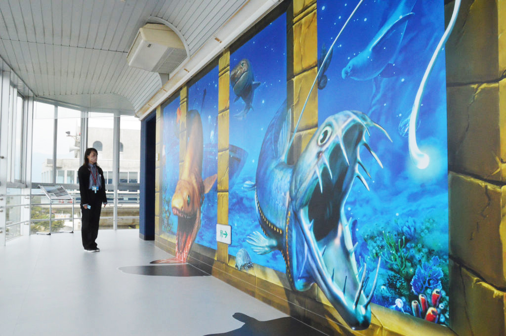 壁から深海魚が飛び出るようなアートが新たに描かれた館内＝沼津市の沼津港大型展望水門施設「びゅうお」