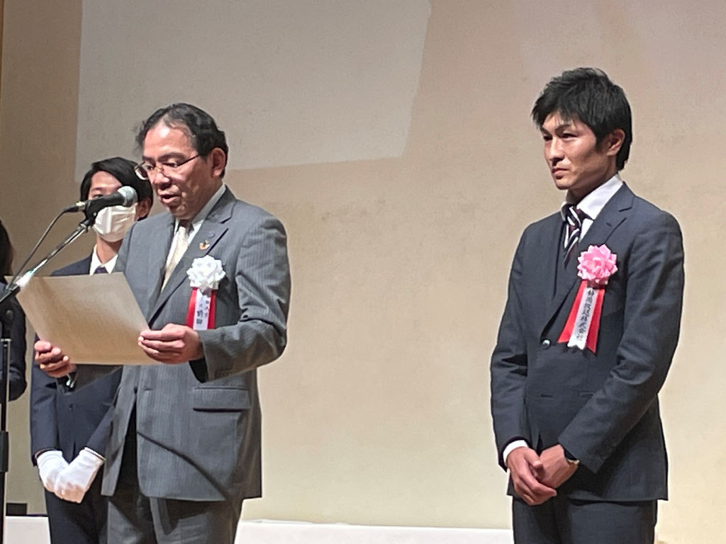 グランプリを授与される静岡放送の和田啓記者（右）＝１２日午後、大阪府吹田市