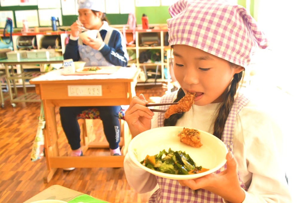 市場にあまり出回らない「ブダイ」の竜田揚げを味わう児童＝１０月下旬、西伊豆町（写真の一部を加工しています）