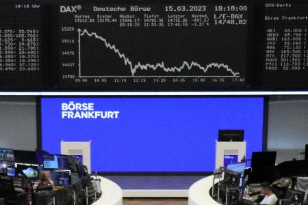 １５日、クレディ・スイス株暴落の影響を受けた株価指数を示すドイツ・フランクフルトの証券取引所のモニター（ロイター＝共同）
