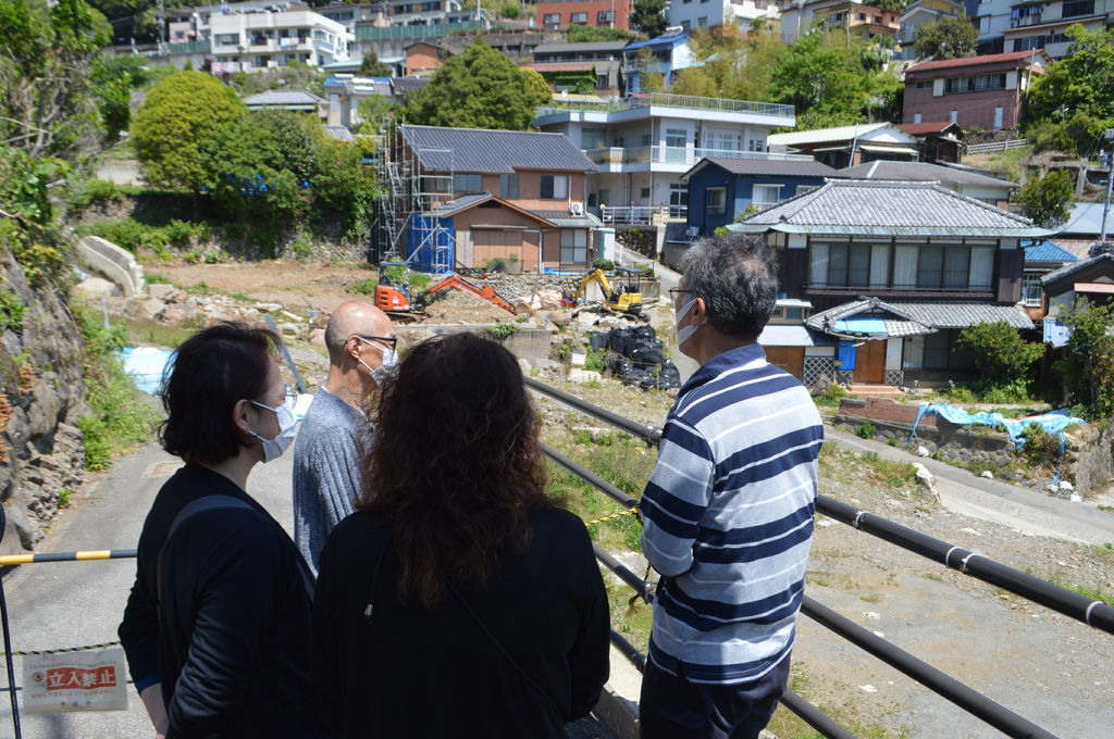 警戒区域の外から被災現場を見つめる被災者＝３日午前、熱海市伊豆山