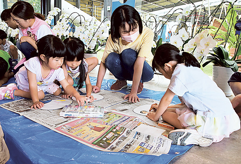 うちわに思い思いに絵を描く園児ら＝浜松市東区の中部日本プラスチック