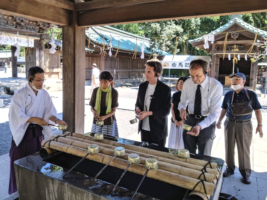 地元の通訳ガイドとともに下見するチャート出意人さん(右から2人目)=三島市の三嶋大社