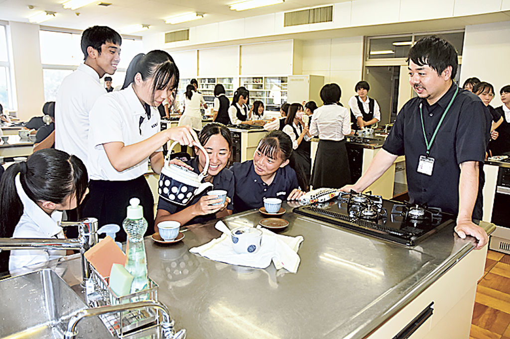岡部さん（右）からおいしいお茶の入れ方を学ぶ生徒＝浜松市中区の浜松商業高