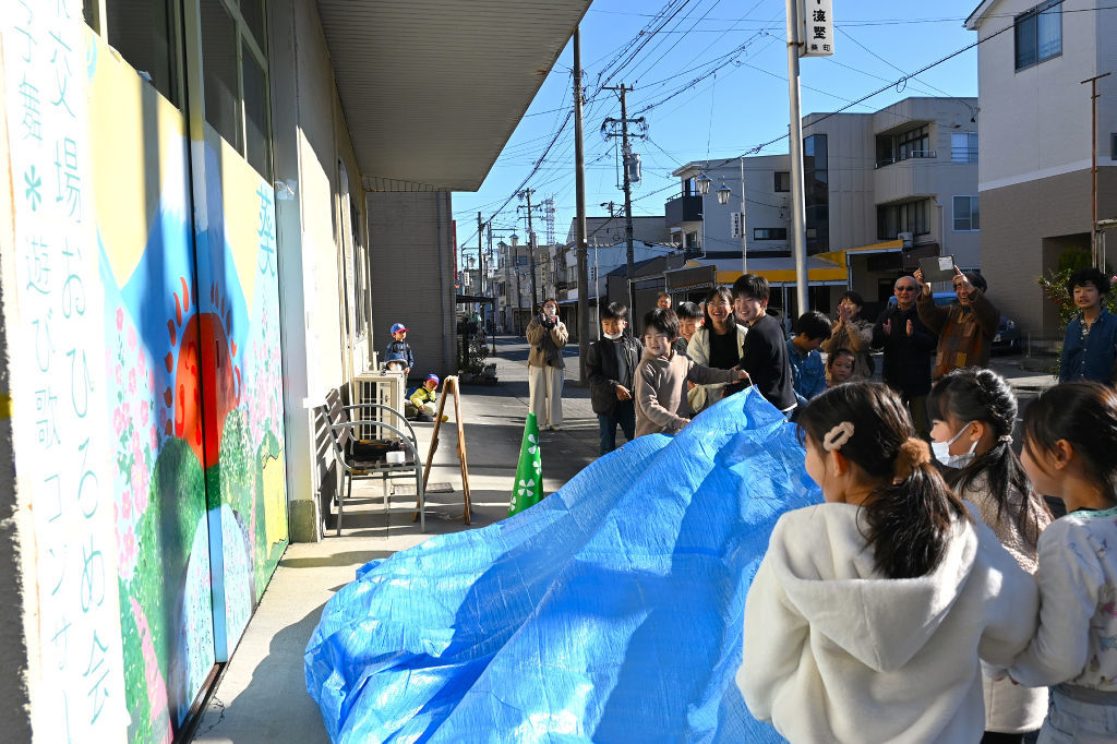 新しいコミュニティースペースのお披露目とともに姿を現した壁画＝静岡市葵区の「海野兼太郎商店」