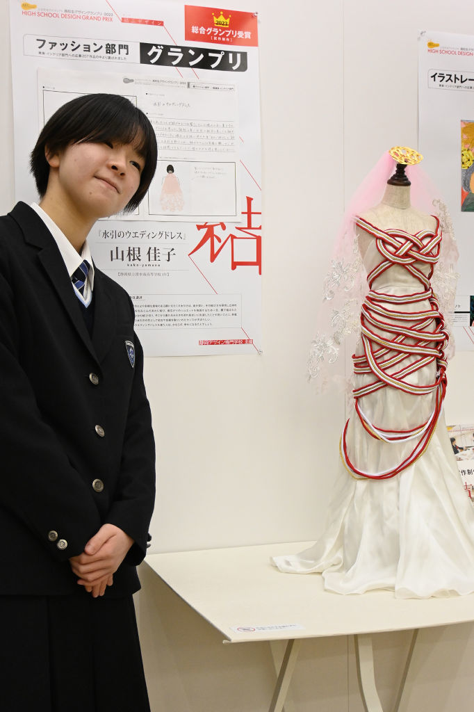 最高賞を受賞した山根さんと試作されたドレス＝静岡市葵区の市民文化会館