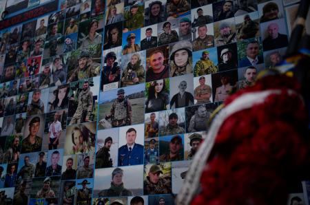 聖ミハイル黄金ドーム修道院の外壁に掲示された、犠牲となったウクライナ兵士らの写真＝２３日、キーウ（共同）