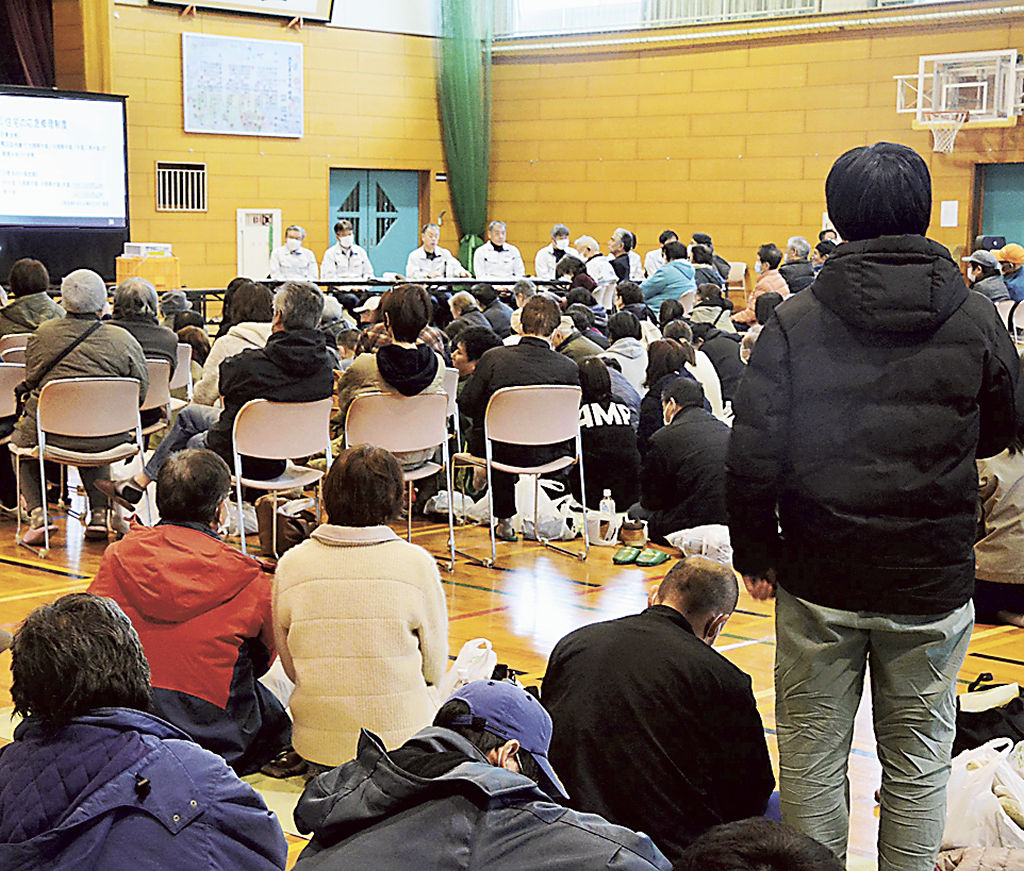 液状化被害の住民説明会で質問する住民の女性（右）＝３月１７日、石川県内灘町