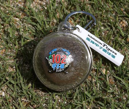 プロ野球阪神と阪神甲子園球場が全国の高校野球部３年生らに贈る「甲子園の土」が入ったキーホルダー（球団提供）