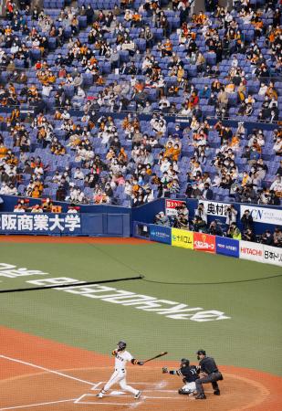 プロ野球日本シリーズ第１戦をマスク姿で観戦する人たち。観客数は収容人数の５０％までに制限された＝２１日、大阪市の京セラドーム大阪