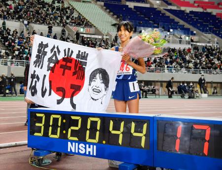 女子１万メートルで３０分２０秒４４の日本新記録をマークして優勝し、笑顔を見せる新谷仁美。東京五輪代表に内定した＝ヤンマースタジアム長居