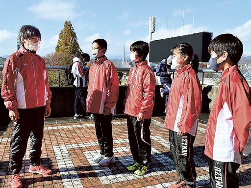 力走した中学生選手をねぎらう平田選手（左）＝草薙陸上競技場